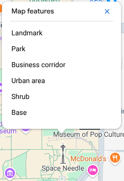 The map inspector opens above the Space Needle and lists six Map Features at that click point: landmark, park, business corridor, urban area, shrub, and base.