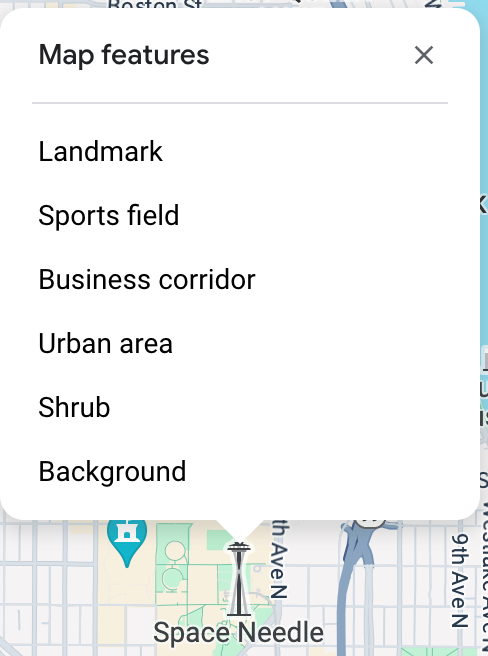 L&#39;inspecteur de carte s&#39;ouvre au-dessus de l&#39;obélisque Space Needle et liste six éléments cartographiques à cet emplacement : un point d&#39;intérêt, un terrain de sport, un axe commercial, une zone urbaine, un arbuste et un arrière-plan.